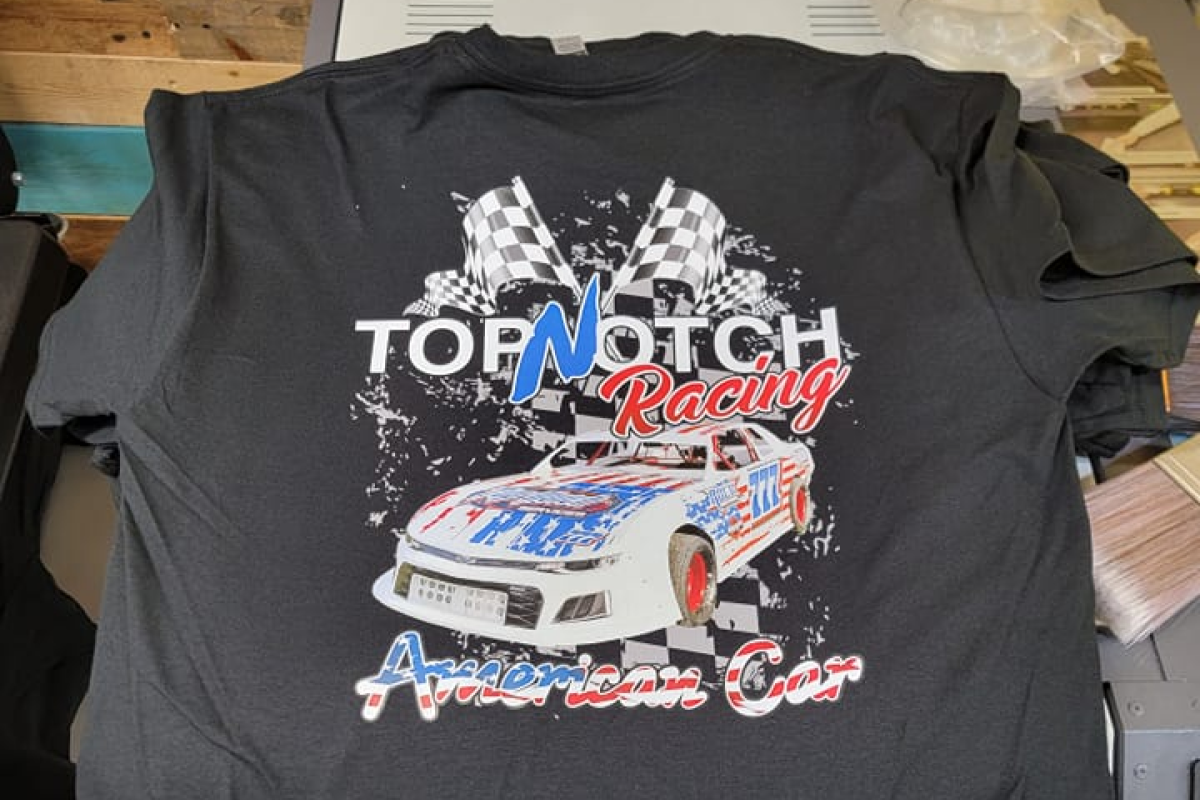 Black shirt with 'Top Notch Racing' and American car graphic.