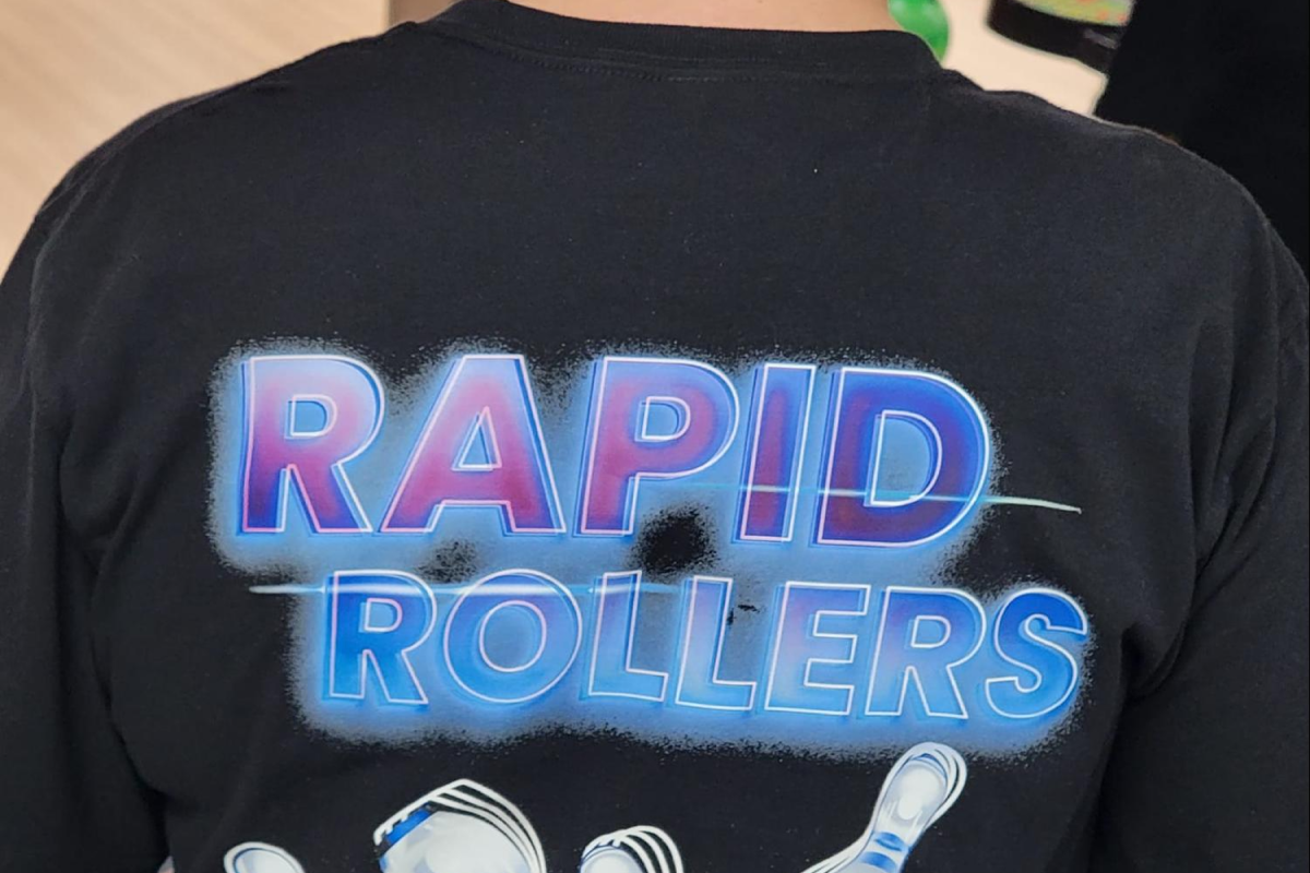 Back view of a shirt with 'Rapid Rollers' and bowling pins graphic.