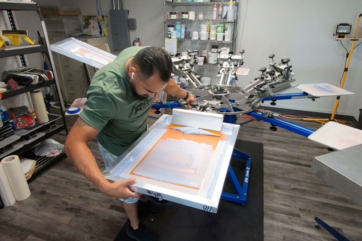 Man aligning screen for printing