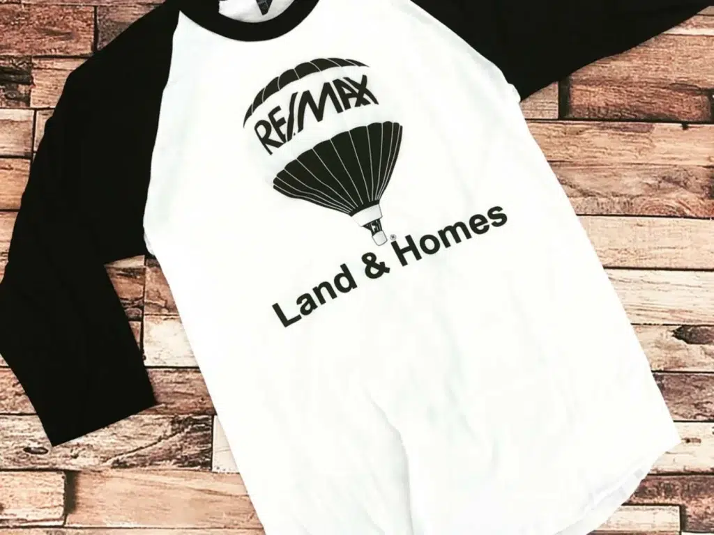RE/MAX Land & Homes shirt.