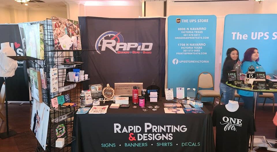 Rapid Printing & Designs booth display.