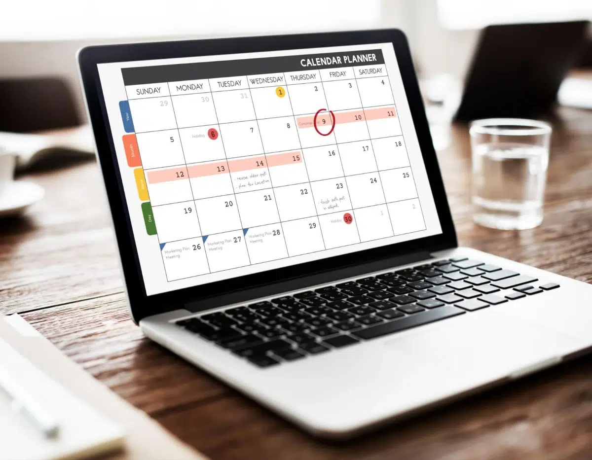 Boost Your Holiday Sales with These Screen Printing Ideas 2 Laptop displaying monthly calendar planner.